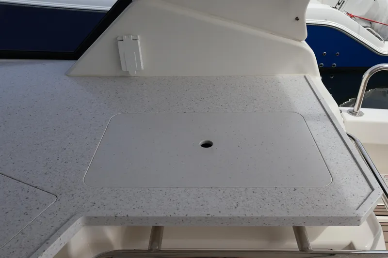  Yacht Photos Pics 2023 Aquila 36 Sport boat deck with speckled countertop and built-in storage.