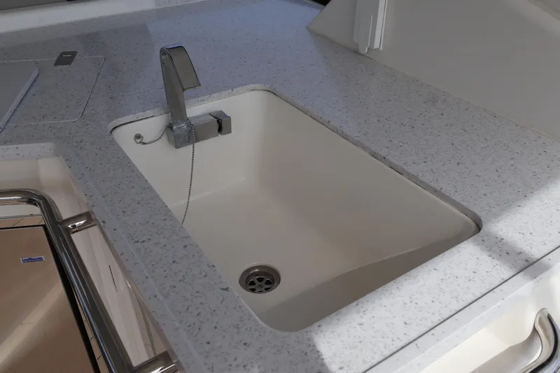  Yacht Photos Pics Modern kitchen sink on 2023 Aquila 36 Sport boat with sleek countertop design.