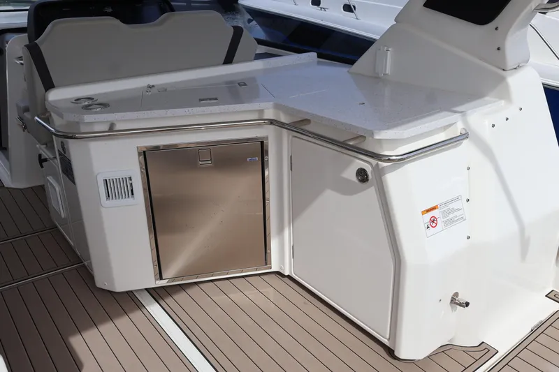  Yacht Photos Pics 2023 Aquila 36 Sport yacht interior with sleek kitchenette and stainless steel appliances.