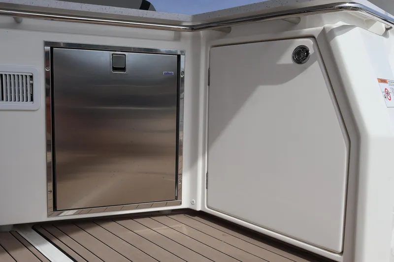  Yacht Photos Pics 2023 Aquila 36 Sport boat interior with stainless steel door and white paneling.