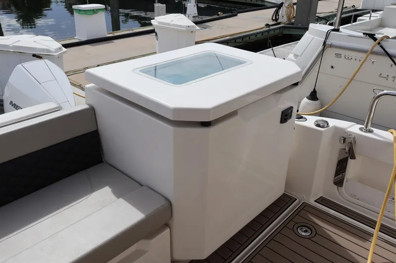  Yacht Photos Pics 2023 Aquila 36 Sport boat interior with seating and storage compartment.