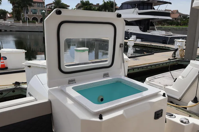  Yacht Photos Pics 2023 Aquila 36 Sport boat with open storage compartment at marina dock.