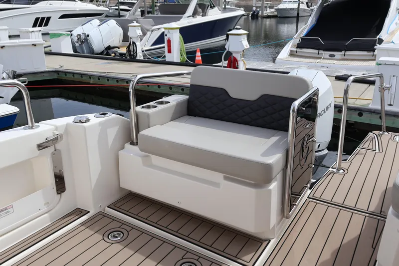  Yacht Photos Pics Aquila 36 Sport 2023 boat with cushioned seating at a marina dock.