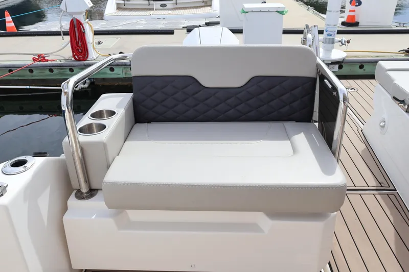  Yacht Photos Pics Luxury seating on 2023 Aquila 36 Sport boat with cup holders, docked at marina.
