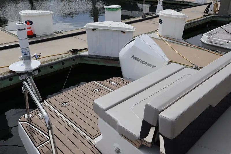  Yacht Photos Pics 2023 Aquila 36 Sport boat docked with Mercury engine visible.