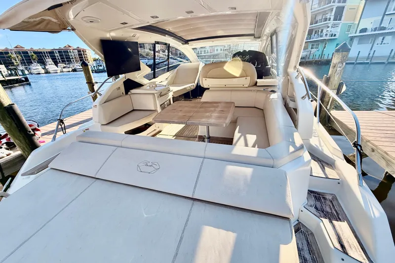  Yacht Photos Pics 2016 Cranchi M44 HT yacht interior with seating, table, and waterfront view.