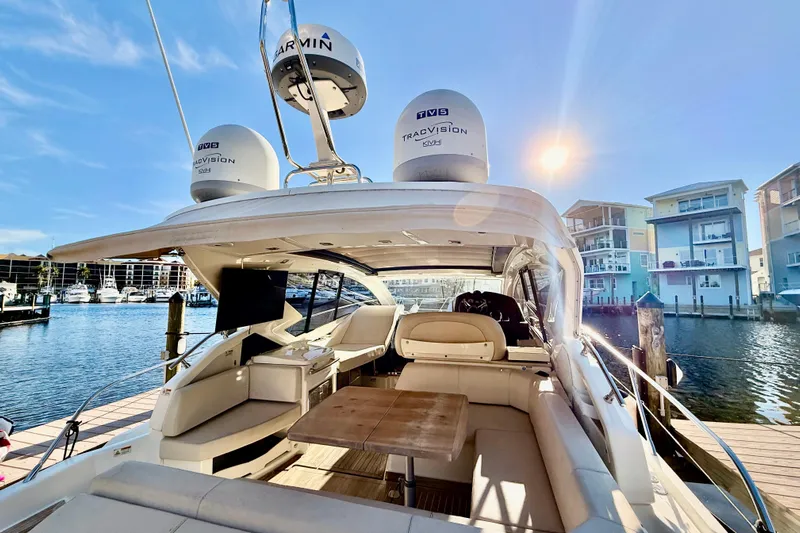  Yacht Photos Pics 2016 Cranchi M44 HT yacht docked, featuring spacious seating and modern navigation equipment.