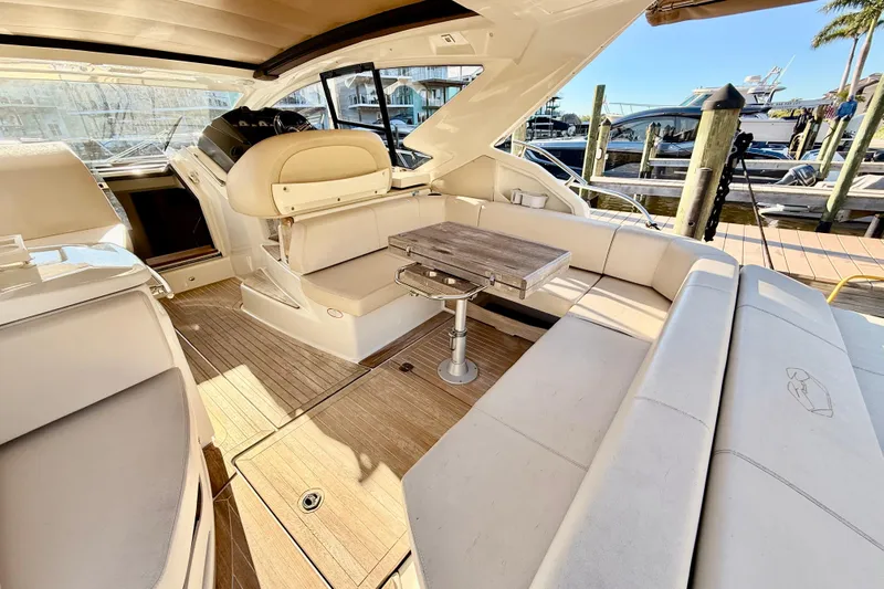  Yacht Photos Pics Luxurious 2016 Cranchi M44 HT yacht interior with elegant seating and wooden table.