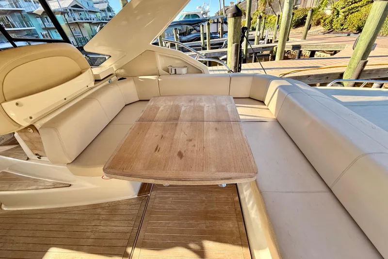  Yacht Photos Pics Luxurious seating area on a 2016 Cranchi M44 HT yacht with wooden table.