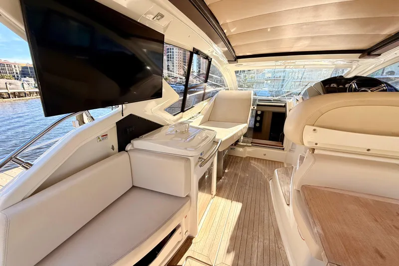  Yacht Photos Pics Luxurious interior of 2016 Cranchi M44 HT yacht with modern seating and large TV.