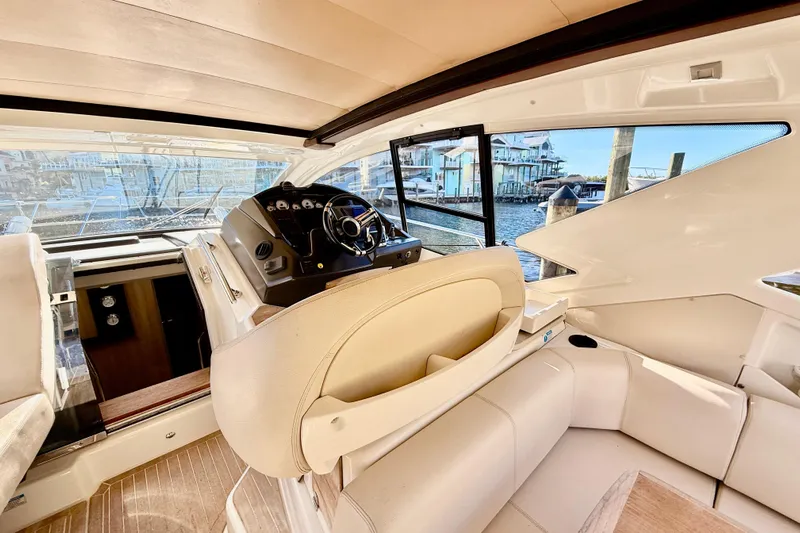  Yacht Photos Pics Interior view of 2016 Cranchi M44 HT yacht with helm and seating area.