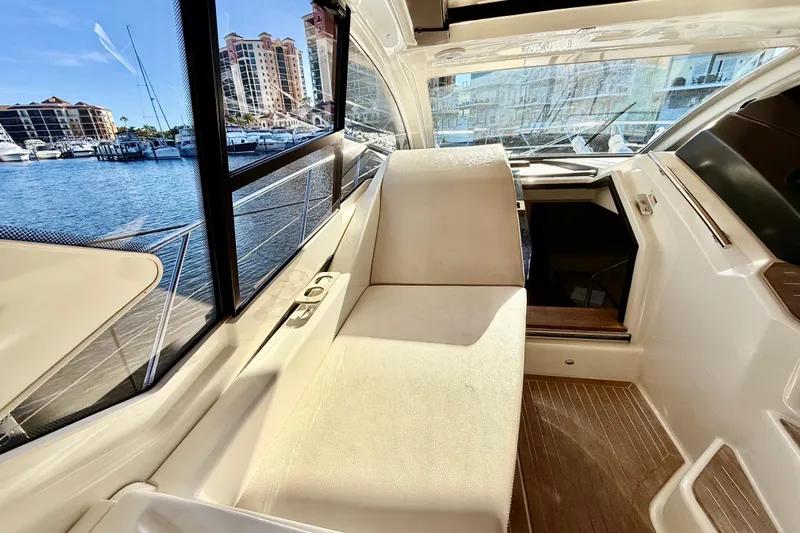  Yacht Photos Pics Interior view of 2016 Cranchi M44 HT yacht with marina backdrop.
