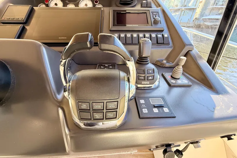 Yacht Photos Pics Control panel of a 2016 Cranchi M44 HT yacht with navigation and throttle controls.