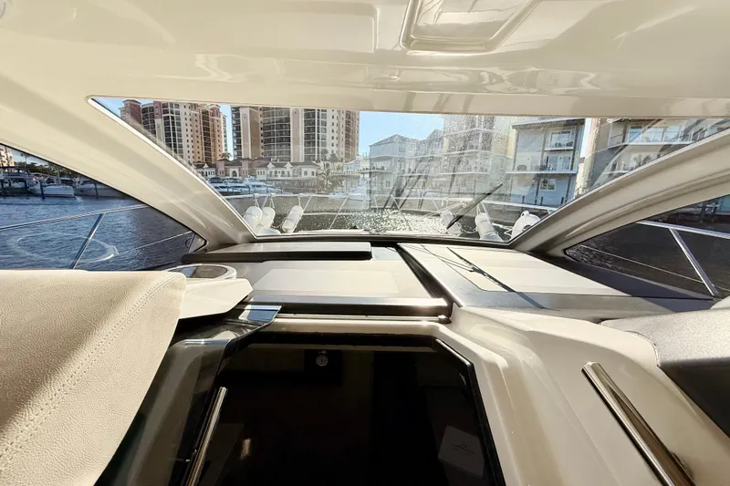 Yacht Photos Pics Interior view of 2016 Cranchi M44 HT yacht with marina backdrop.