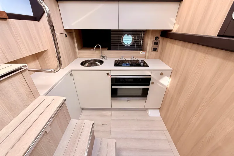  Yacht Photos Pics Modern kitchen interior of 2016 Cranchi M44 HT yacht with sleek design and compact appliances.