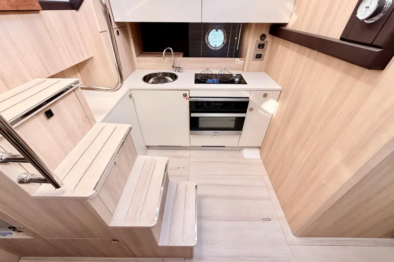  Yacht Photos Pics Modern kitchen interior of 2016 Cranchi M44 HT yacht with sleek design and compact layout.
