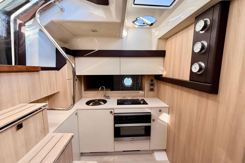  Yacht Photos Pics Modern kitchen interior of 2016 Cranchi M44 HT yacht with sleek design and appliances.