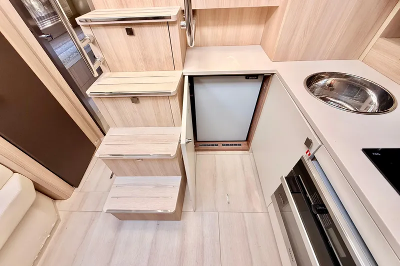  Yacht Photos Pics Interior of 2016 Cranchi M44 HT yacht with modern kitchen and wooden stairs.