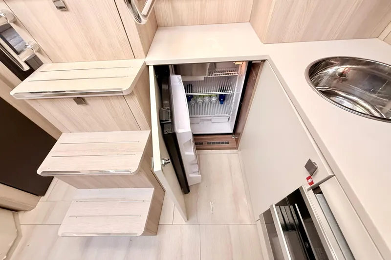  Yacht Photos Pics Modern kitchen area in 2016 Cranchi M44 HT yacht with fridge and sink.