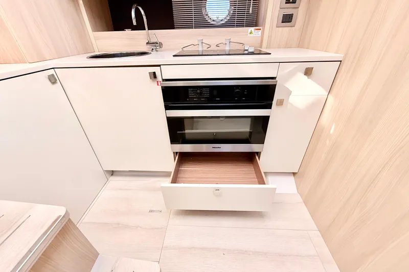  Yacht Photos Pics Modern kitchen interior of 2016 Cranchi M44 HT yacht with sleek cabinetry and appliances.