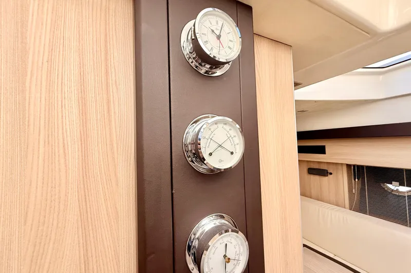  Yacht Photos Pics Interior of 2016 Cranchi M44 HT yacht with elegant wooden paneling and chrome gauges.