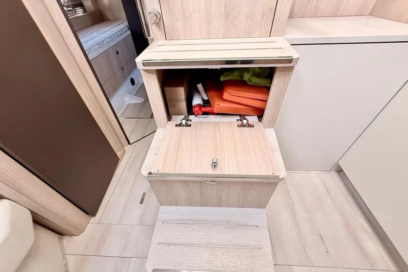  Yacht Photos Pics Interior storage compartment in 2016 Cranchi M44 HT yacht, featuring light wood finish and organized space.