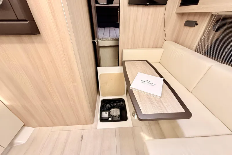  Yacht Photos Pics Interior of 2016 Cranchi M44 HT yacht with seating and storage compartment.