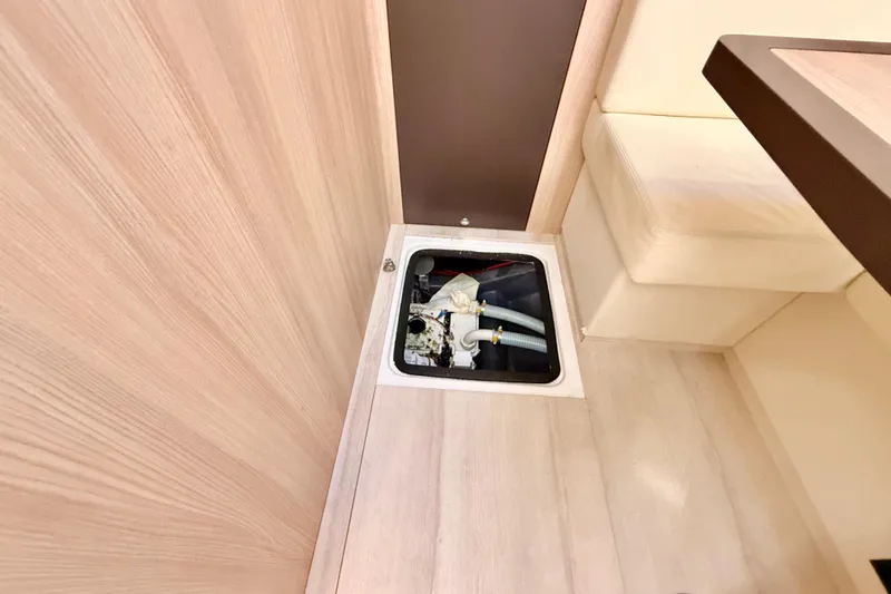  Yacht Photos Pics Floor compartment in 2016 Cranchi M44 HT yacht interior, showing plumbing components.