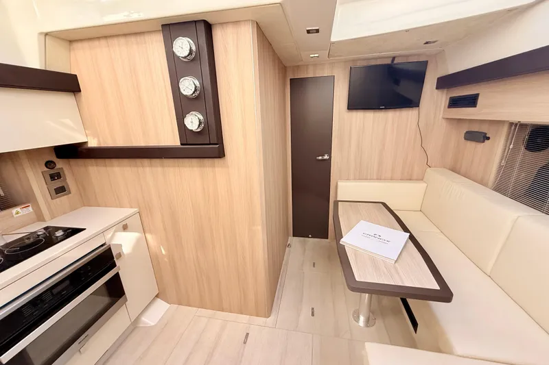  Yacht Photos Pics Luxurious interior of 2016 Cranchi M44 HT yacht with modern kitchen and seating area.