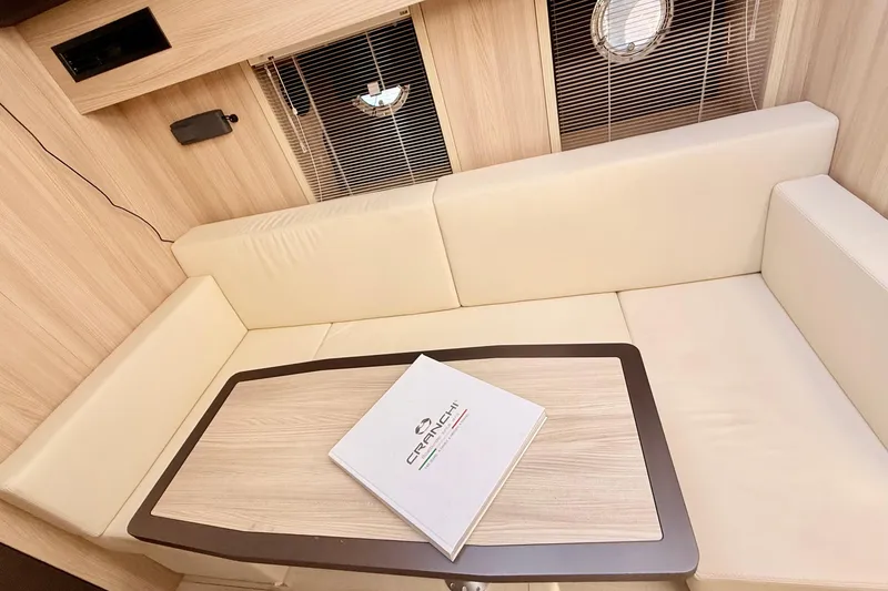  Yacht Photos Pics Interior of 2016 Cranchi M44 HT yacht with beige seating and table.