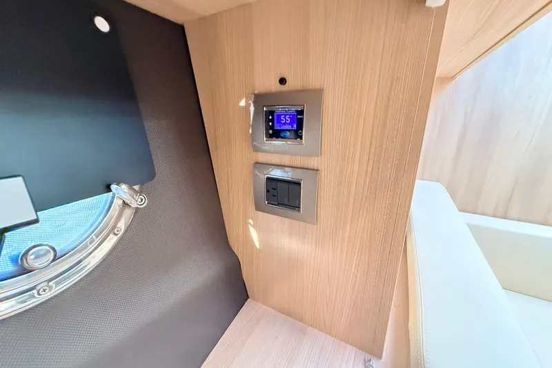  Yacht Photos Pics Control panel and porthole inside 2016 Cranchi M44 HT yacht cabin.