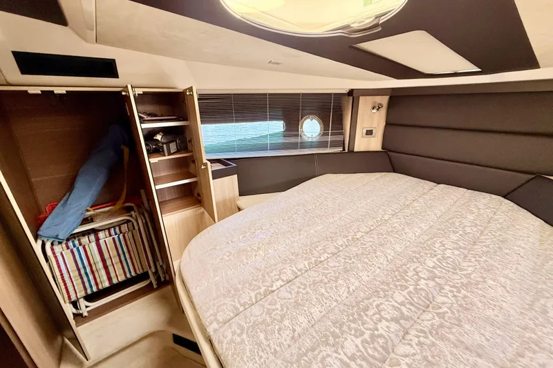  Yacht Photos Pics Luxurious cabin interior of 2016 Cranchi M44 HT yacht with bed and storage.