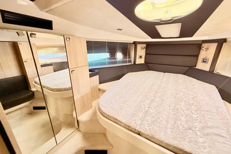  Yacht Photos Pics Luxurious interior of 2016 Cranchi M44 HT yacht with spacious bed and modern design.