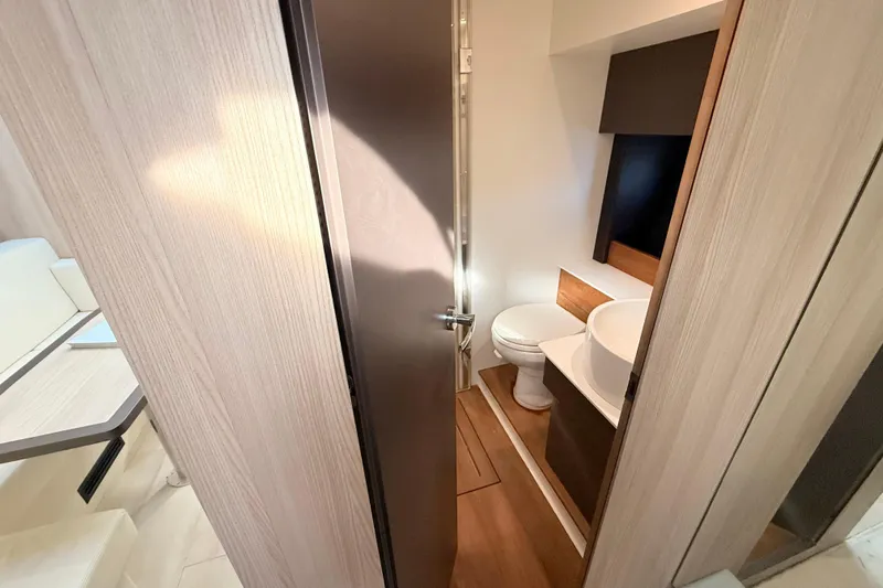  Yacht Photos Pics 2016 Cranchi M44 HT yacht bathroom with modern fixtures and wooden accents.