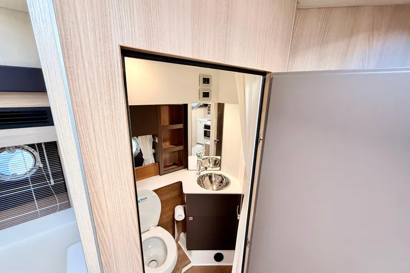  Yacht Photos Pics Interior of 2016 Cranchi M44 HT yacht bathroom with modern fixtures and wood accents.