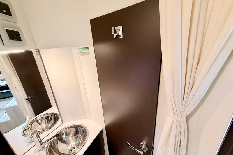  Yacht Photos Pics Modern bathroom interior of 2016 Cranchi M44 HT yacht with sleek sink and mirror.