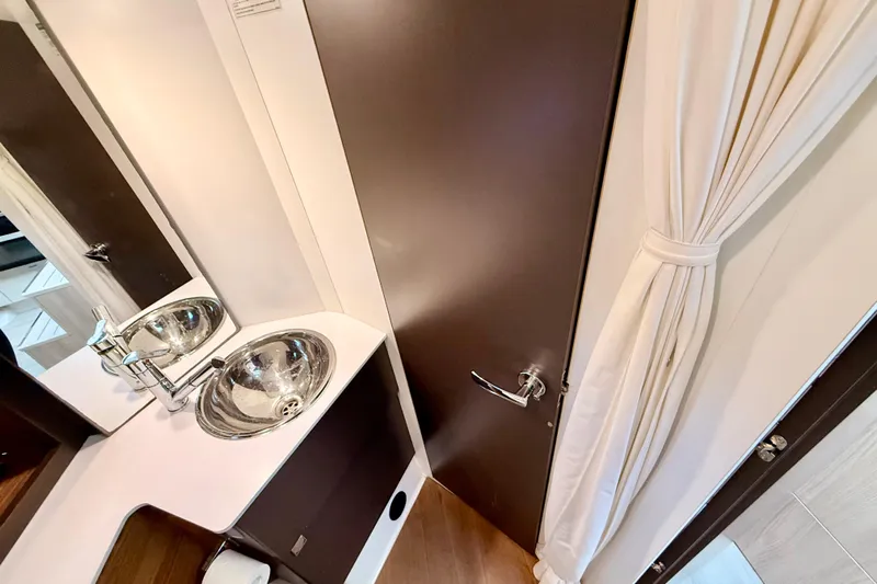  Yacht Photos Pics Luxurious bathroom interior of 2016 Cranchi M44 HT yacht with modern sink and fixtures.