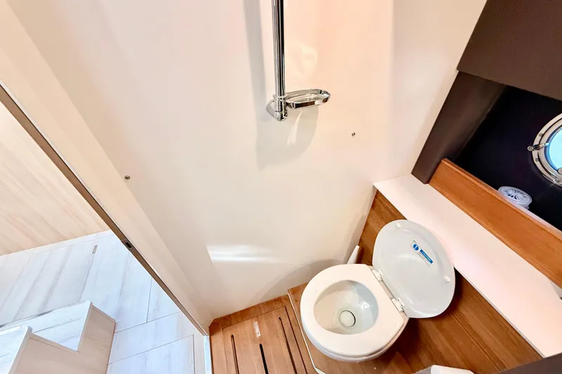  Yacht Photos Pics 2016 Cranchi M44 HT yacht bathroom with modern toilet and wooden accents.