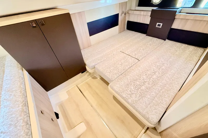  Yacht Photos Pics 2016 Cranchi M44 HT yacht interior with elegant bedding and wooden cabinetry.