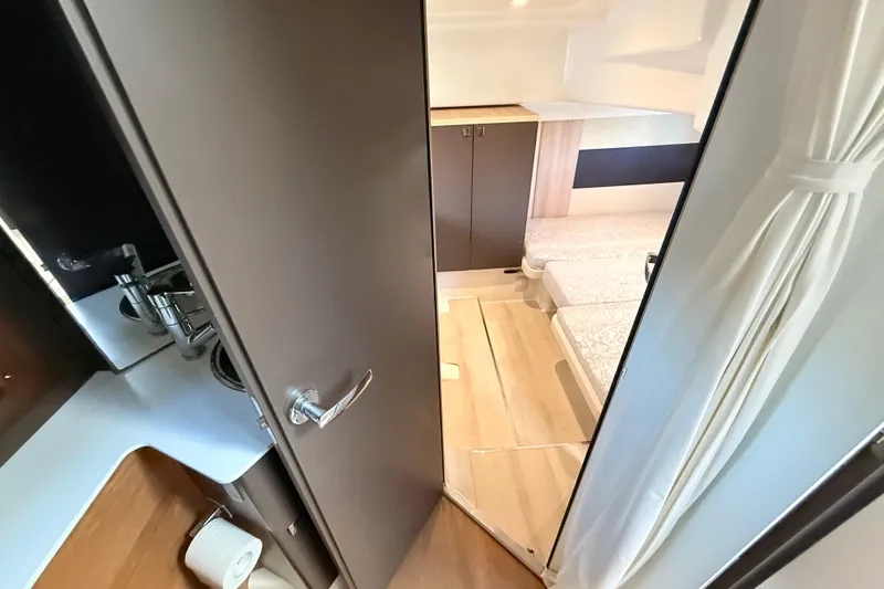  Yacht Photos Pics Interior view of 2016 Cranchi M44 HT yacht cabin with modern design and cozy bedding.