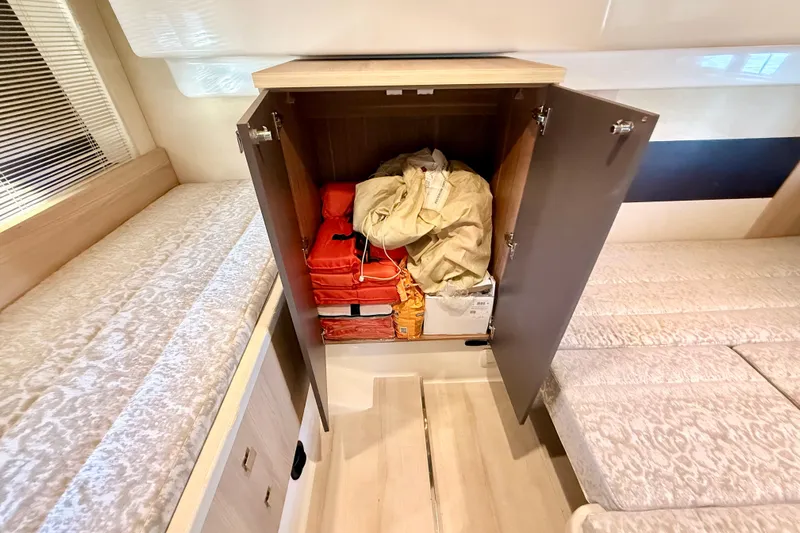  Yacht Photos Pics Storage cabinet in 2016 Cranchi M44 HT yacht, containing life jackets and safety equipment.