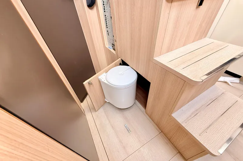  Yacht Photos Pics Interior of 2016 Cranchi M44 HT yacht with wooden cabinetry and hidden trash bin.