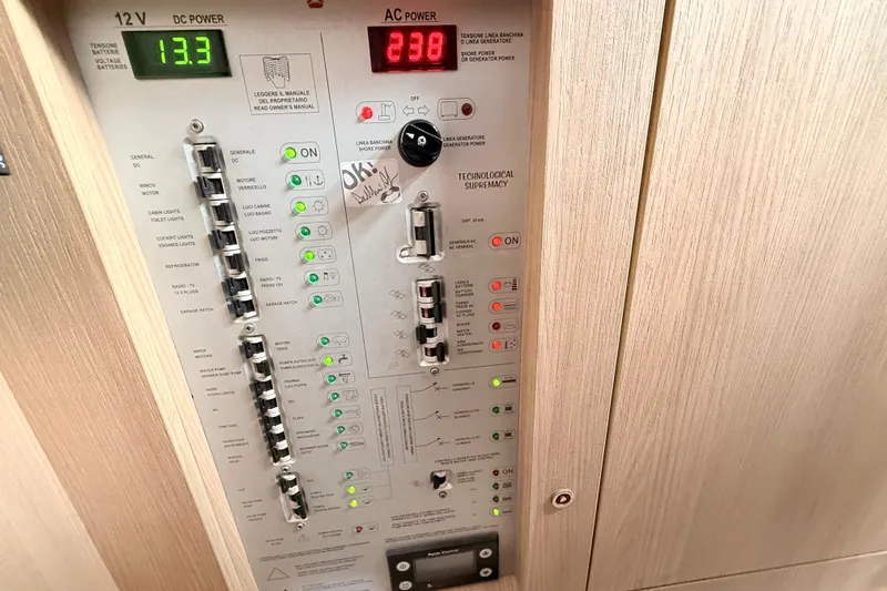  Yacht Photos Pics Control panel of a 2016 Cranchi M44 HT yacht, displaying DC and AC power readings.