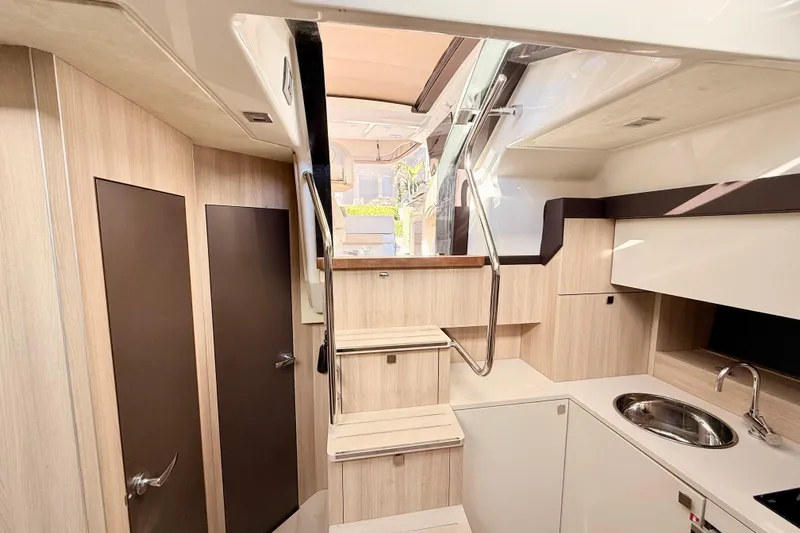  Yacht Photos Pics Interior of 2016 Cranchi M44 HT yacht with modern kitchen and stairs.