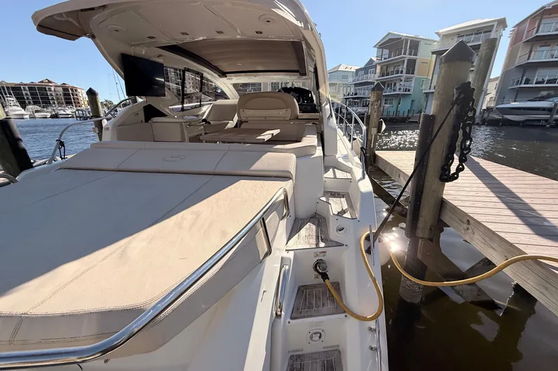  Yacht Photos Pics 2016 Cranchi M44 HT yacht docked at marina, showcasing luxurious deck and seating area.