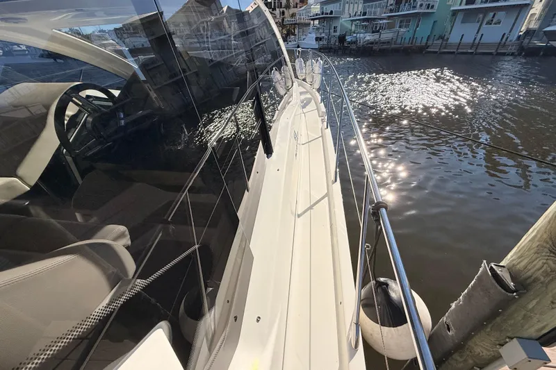  Yacht Photos Pics 2016 Cranchi M44 HT yacht docked, reflecting sunlight on water.