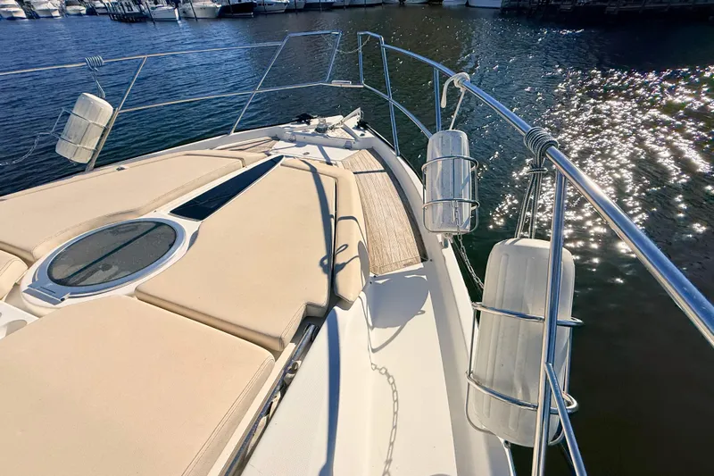  Yacht Photos Pics 2016 Cranchi M44 HT yacht deck with sun pads and railings on a sunny day.