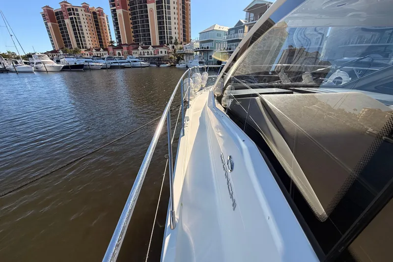  Yacht Photos Pics 2016 Cranchi M44 HT yacht docked near waterfront buildings and marina.