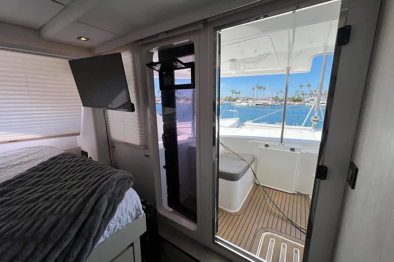 La Grande Bellezza Yacht Photos Pics Interior of 2019 Leopard 58 yacht with bedroom and view of marina through open door.