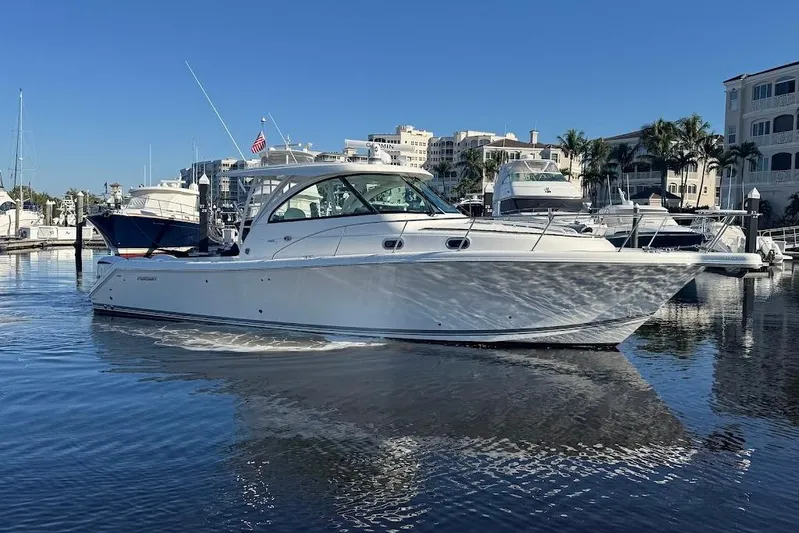  Yacht Photos Pics 2021 Pursuit OS 385 Offshore boat docked in a marina under clear blue skies.